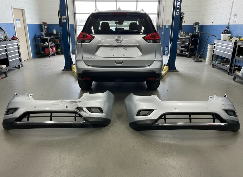 Overhead shot showing a vehicle from the rear with close-up details of a damaged bumper alongside a new replacement bumper...